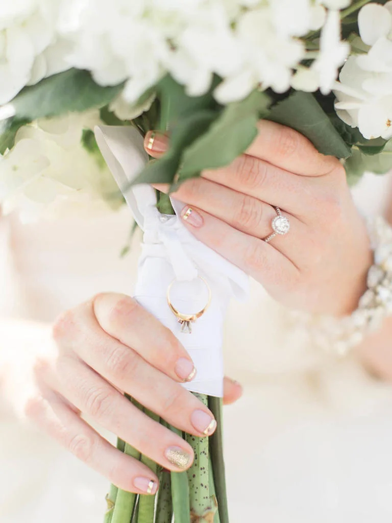 PHOTO BY JILLIAN MICHELLE PHOTOGRAPHY For a subtle and unexpected take on the traditional French manicure, offset gold stripes with one glittery nail. It's a look guaranteed to draw eyes to your fingers—and, of course, your ring. From the album A Bright, Bayside Wedding at the Lesner Inn in Virginia Beach, Virginia