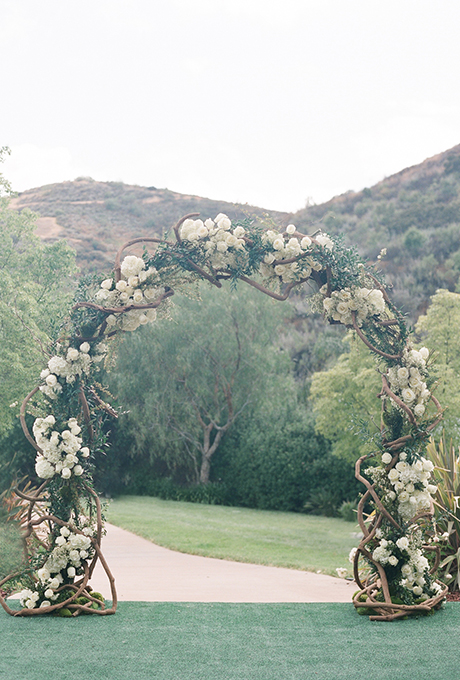 A classic arch of intertwining branches, hydrangeas, and roses. Photo: Diana McGregor Photography