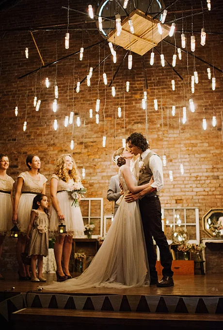 An urban ceremony altar with hanging edison bulb chandelier. Photo: Jac and Heath Photography