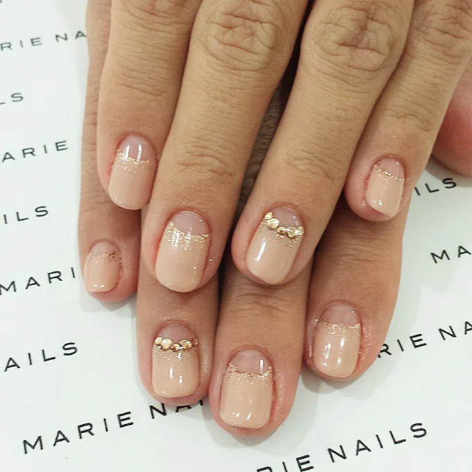 A nude manicure with hints of rose gold. Photo: Marie Nails via Instagram