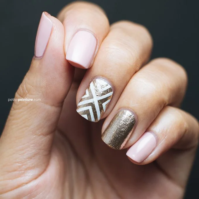 A pink-and-gold manicure with a patterned accent nail. Photo: Courtesy of Petite Peinture