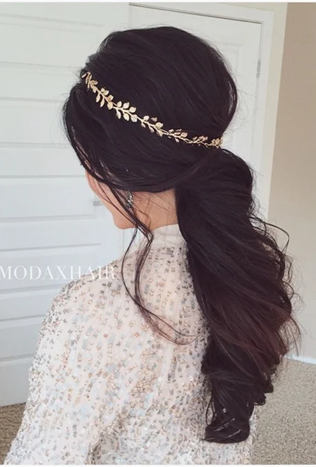 Channel your inner goddess by dressing up your swept-back ponytail with a gold tiara. Photo: Ulyana Aster