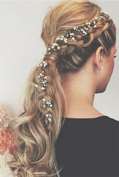 A gently wrapped low ponytail gives you that perfectly ethereal and undone effect that will look effortlessly gorgeous. Photo: Wedding Hair Company via Instagram