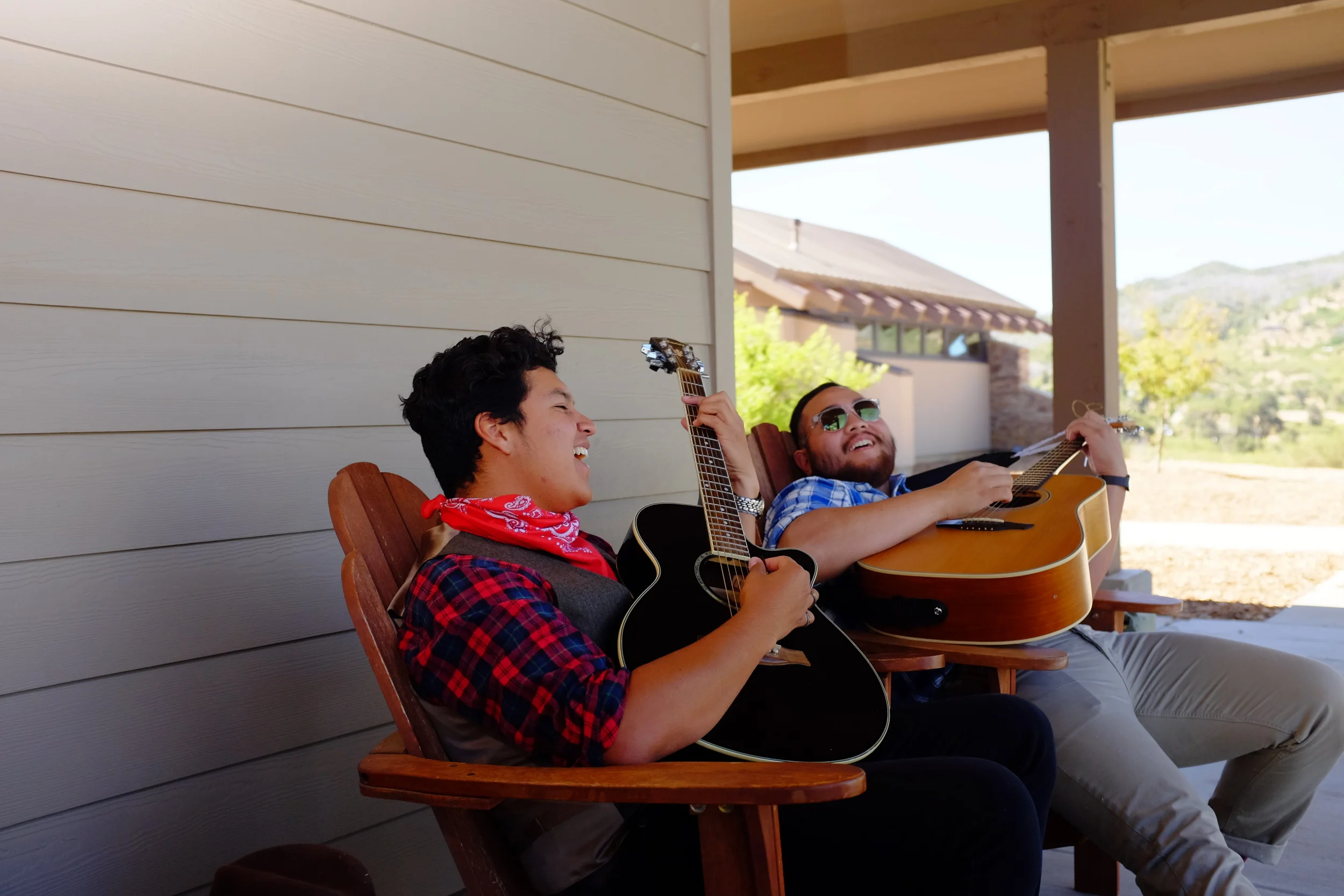 Musicians Angel and Matthew relax on the patio and play some music