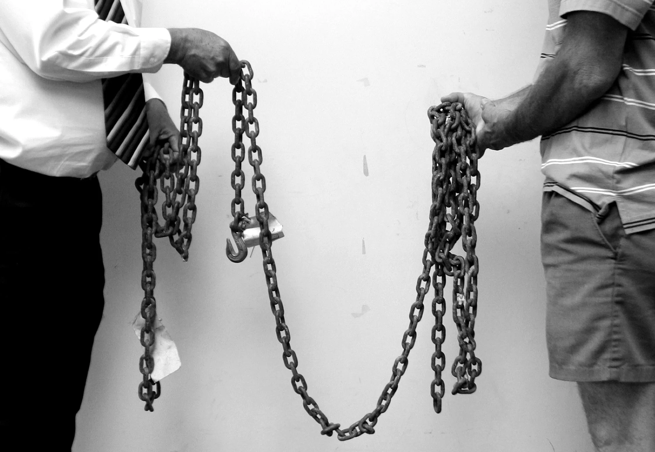  Ten years after the hate crime murder of James Byrd Jr., Jasper County criminal district attorney's Mike Wilson (left) and Richard Drake (right), hold the chain used to drag Byrd behind the pick-up truck on June 7, 1998. 