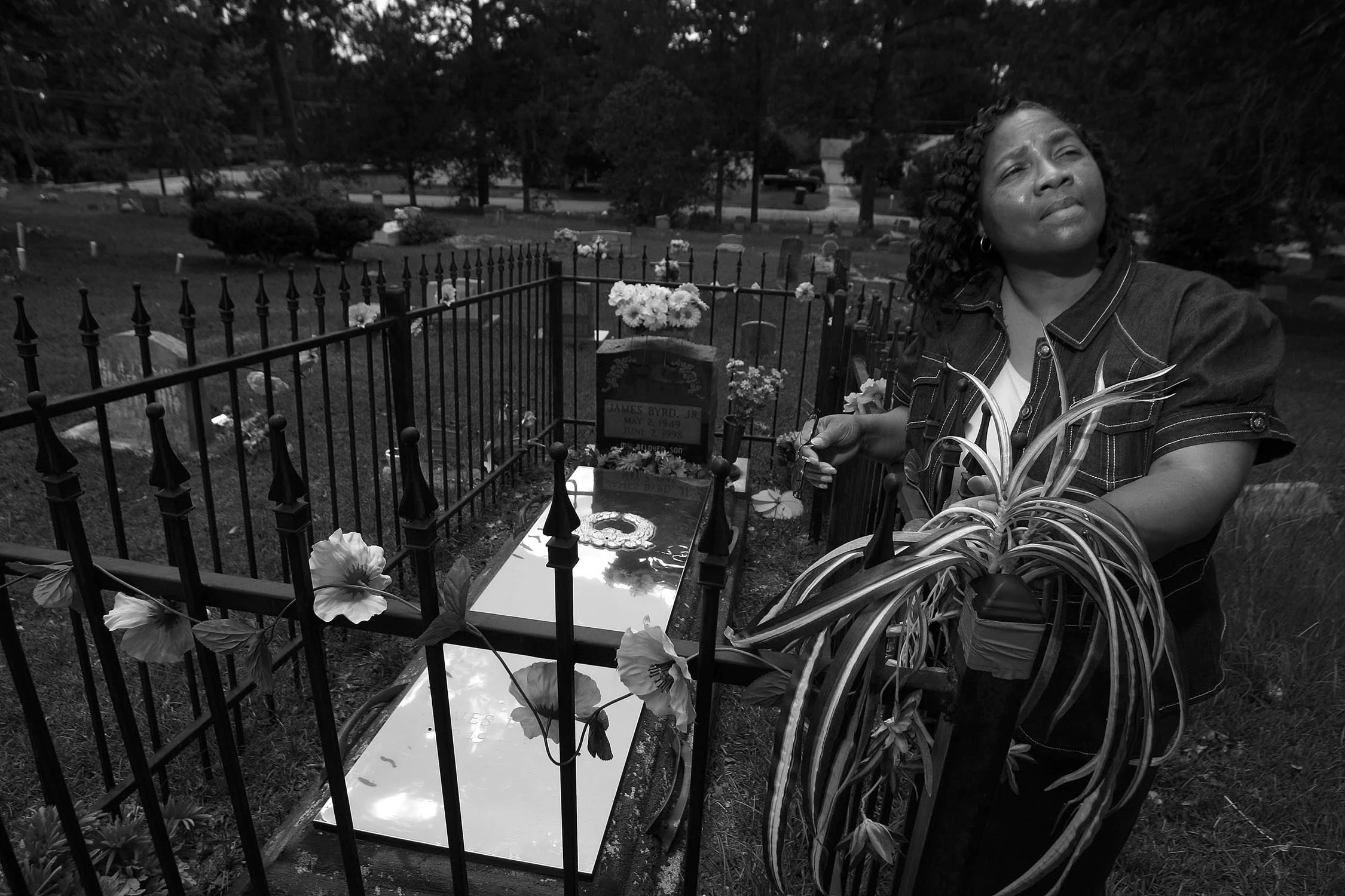     Betty Boatner, one of Byrds six sisters, stands next her brother's grave in the Jasper City Cemetery. Boatner says she forgives her brother's killers, and says the community has been changed for the better through his death.&nbsp;However, she nev