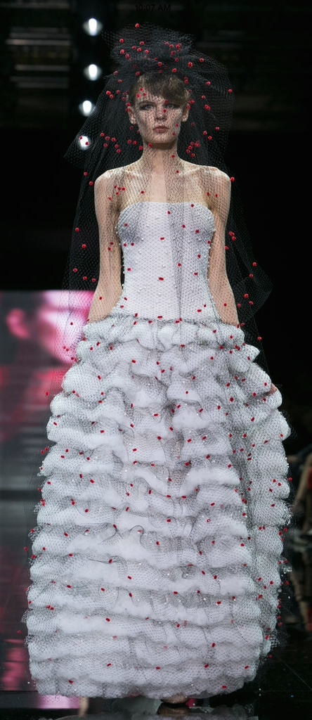 Armani's narrow ruffled balloon skirt and allover embellished veil gives this the feel of a wedding gown, but there's no mistaking is modern feel.