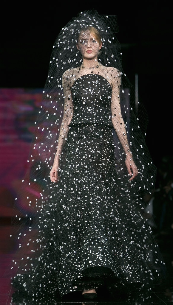A woman in a gown in black while snowing is what I see in Armani's gown and veil, and the juxtaposition is poetic. And the natural lips instead of the typical red is surprisingly sexy! 