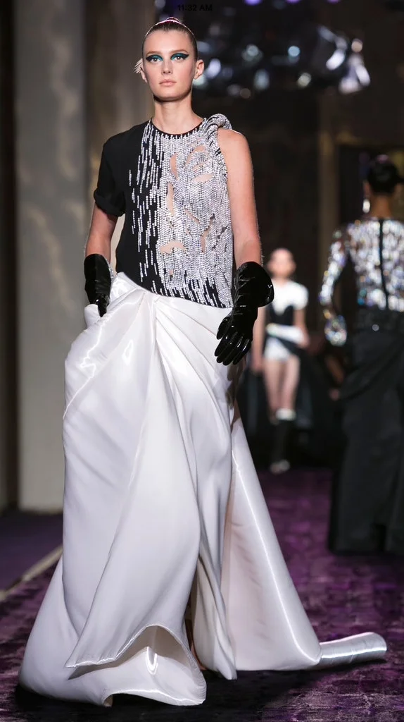 There's no truer evidence that street style has transcended seen in Versace's gown. It manages to look comfortable and glamorous at the same time. The leather gloves add texture, the slouch of them add to the overall casual effect.