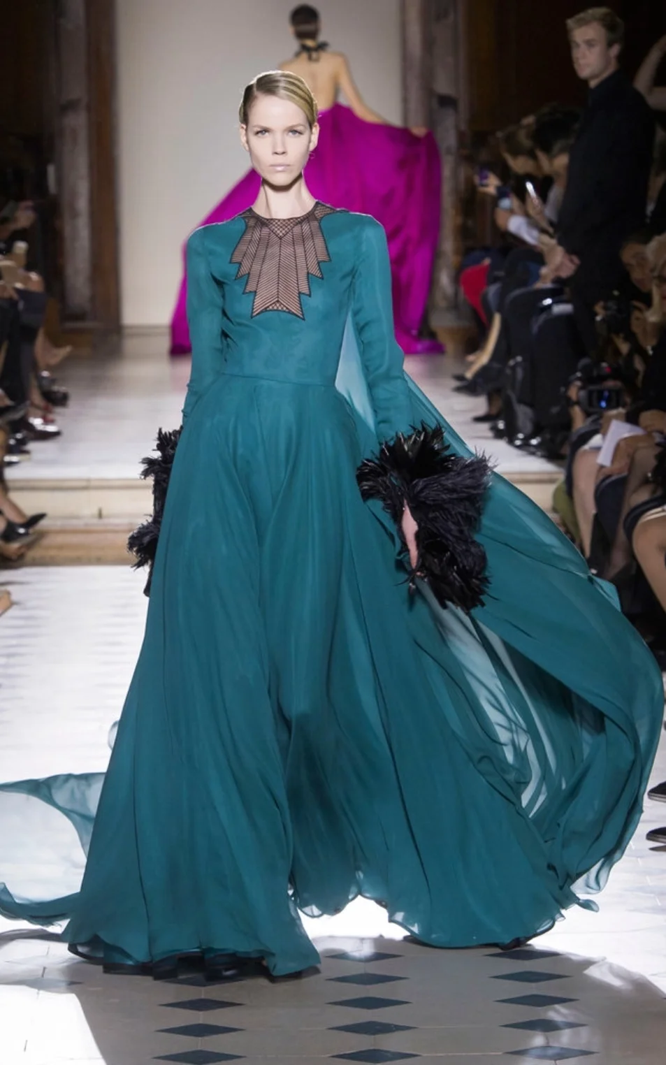 Julien Fournié infused art deco glamour into this gown at the neckline and the feathered cuffs. 
