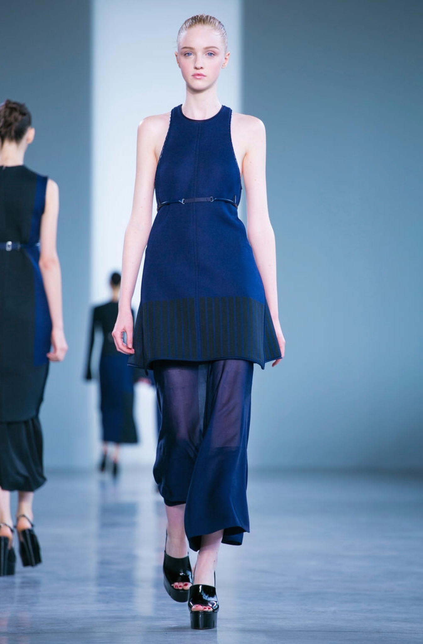 Calvin Klein pairs sheer culottes with a sleeveless sweater tunic.