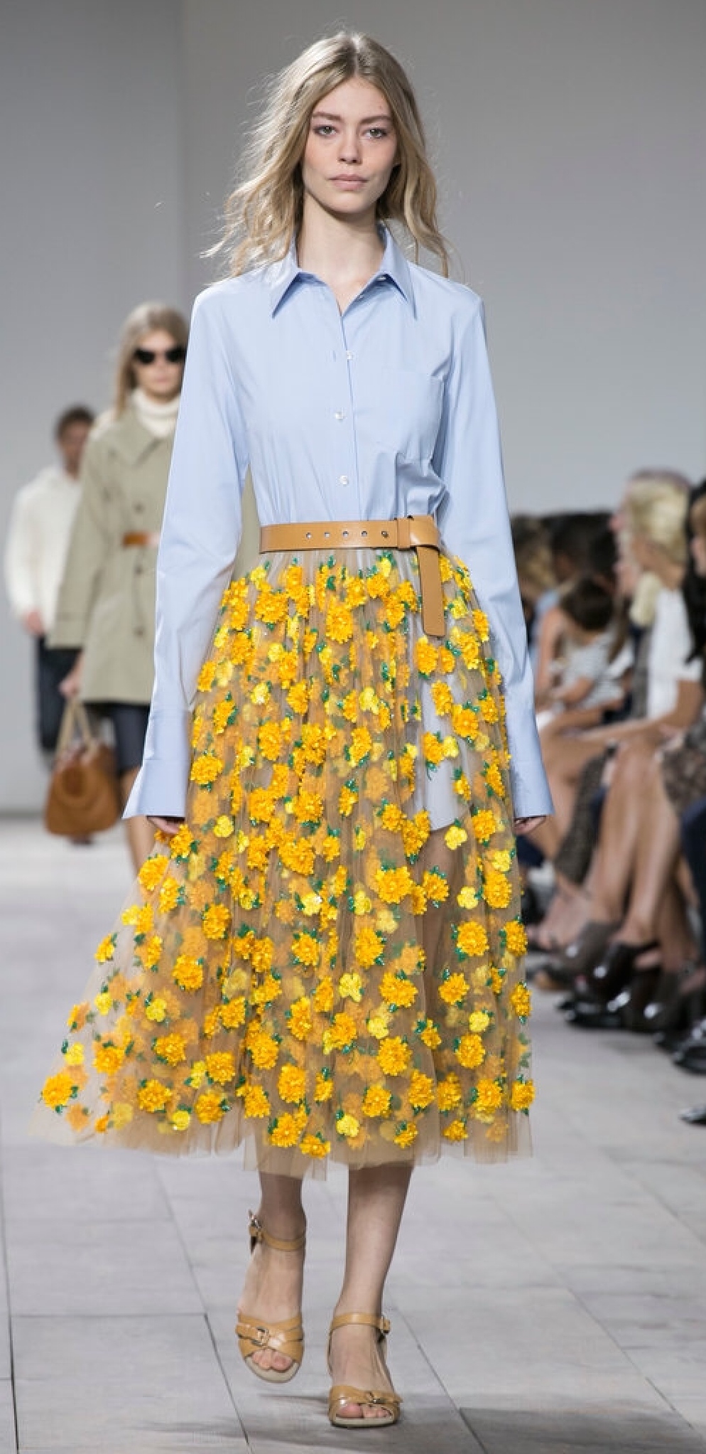 Michael Kors used skin-toned layers topped with flowers which gives the feeling of walking through the garden...gorgeous!