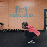With your hands behind your head, complete a low squat, jump up, and complete another — 15 in a row!