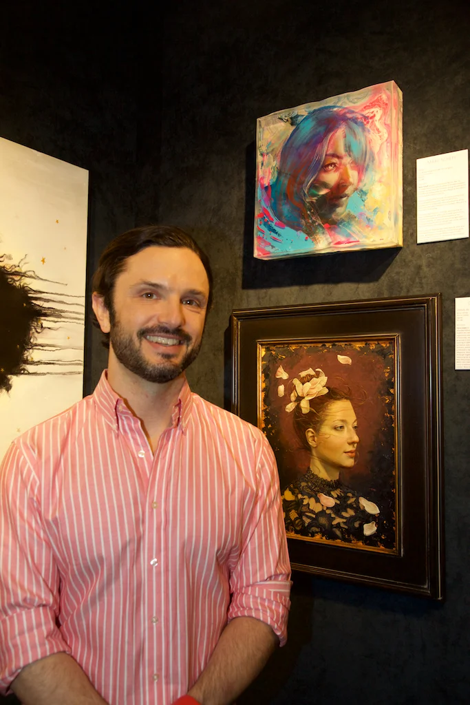 Marc Scheff with his paining above Dana Hawk’s. Photo courtesy Robin Damore, March 9, 2019.
