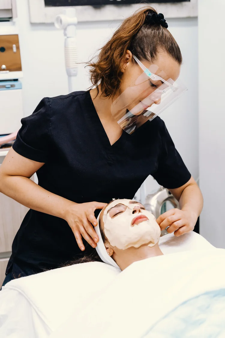 Katherine performing a facial treatment on a client
