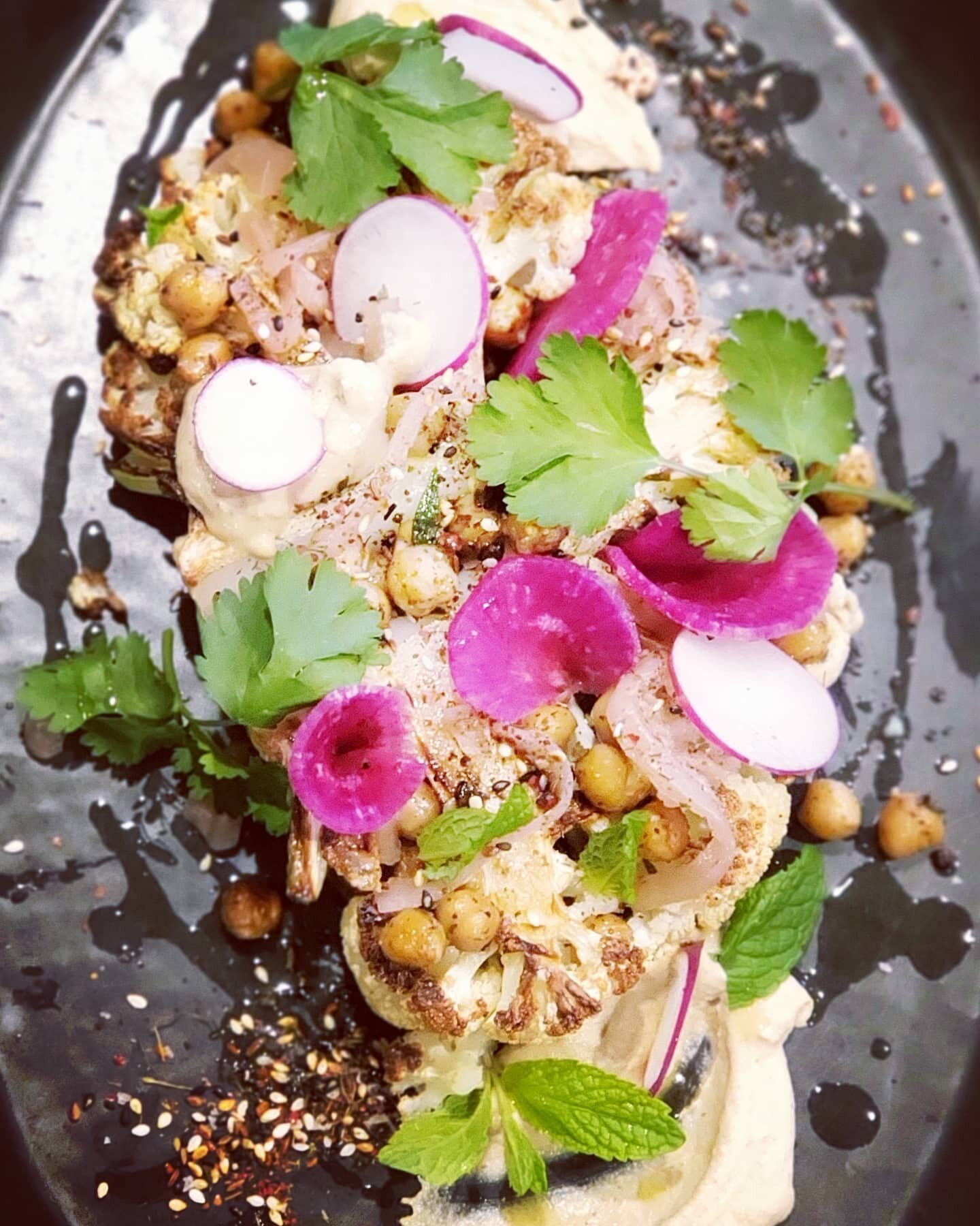 We've been working on our vegan menu - Seared cauliflower steaks, chickpeas, tahini-lemon cream, pickled red onions and za'atar. 🍽