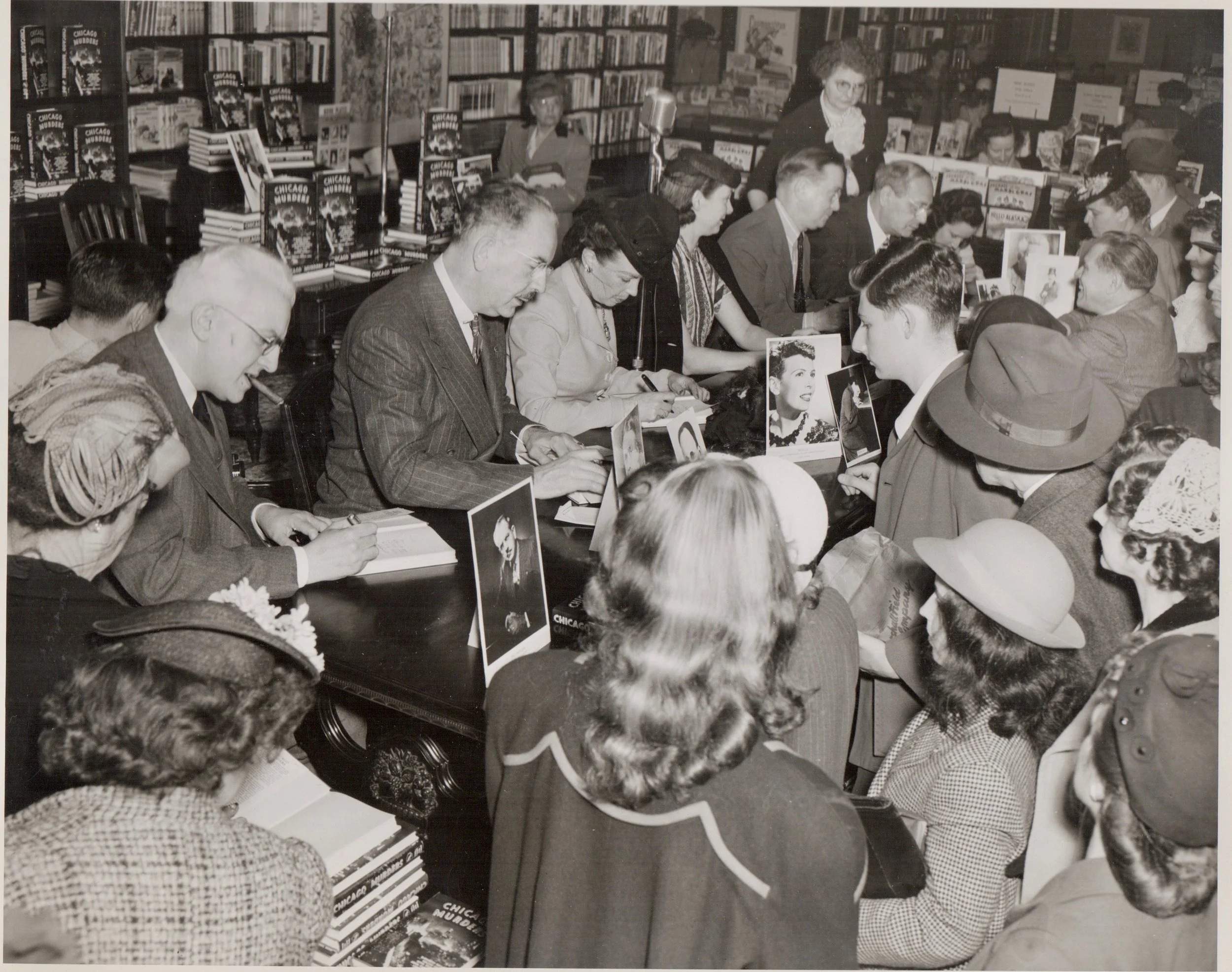 The autograph party, with six of the seven of the contributors. It looks like the kind of assembly line that Henry Ford would be proud of. Starrett is seated to the left, the ever present cigar in evidence. He is seated at the wrong place. Look for his photo, slightly obscured, at the far right of the table. The picture in front of Starrett's portrait is of Dr. Thomas Neill Cream.