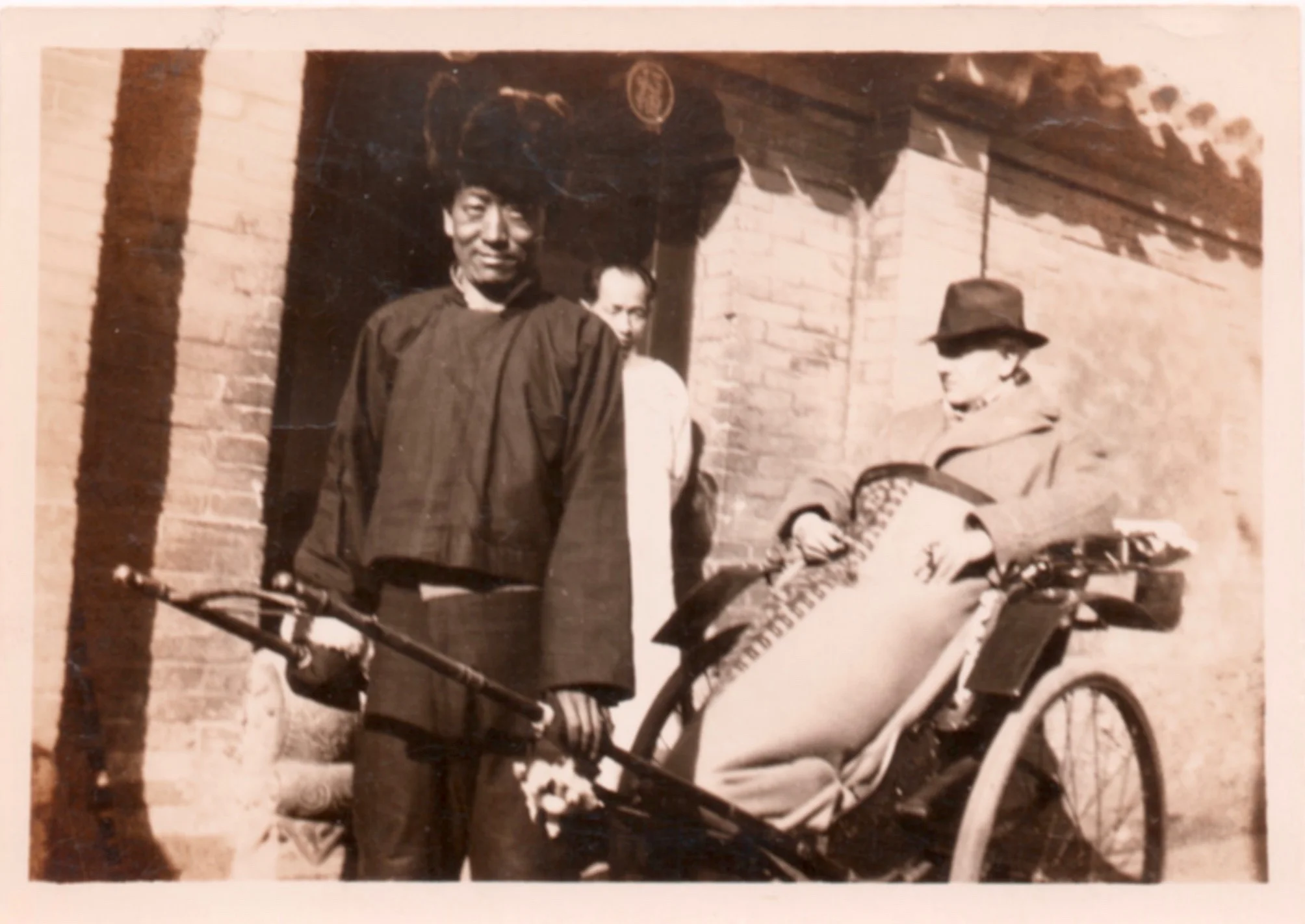 The fellow in white, hidden by the rickshaw driver, is Hsu, Starrett's chief servant while living in Peking. Notice that even while in China, Starrett still managed to find a cigar.
