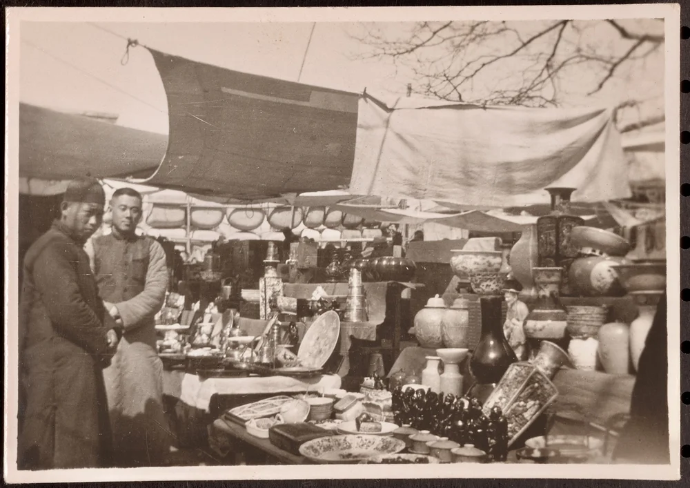 A sidewalk vendor. There are many similiar photos in the Starrett archive.