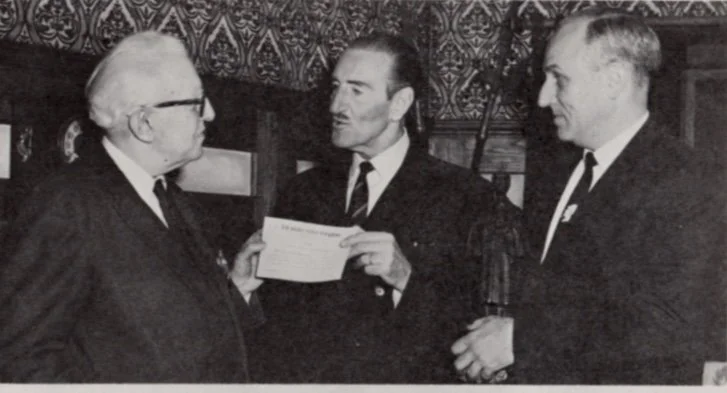 Starrett awarding Basil Rathbone membership in the Hounds of the Baskerville (sic), with Robert Hahn. 1967. From the obscure Kohnstamm Co. employee newsletter, the Kronicle.