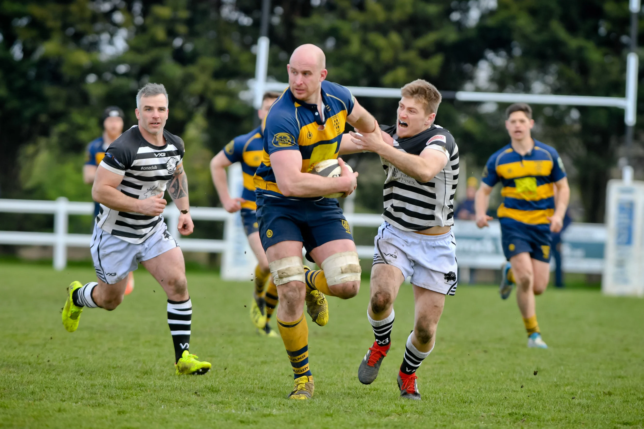 On the charge! Coleman fends off a would-be tackler in his final game as captain. Photo Credit: David Purday