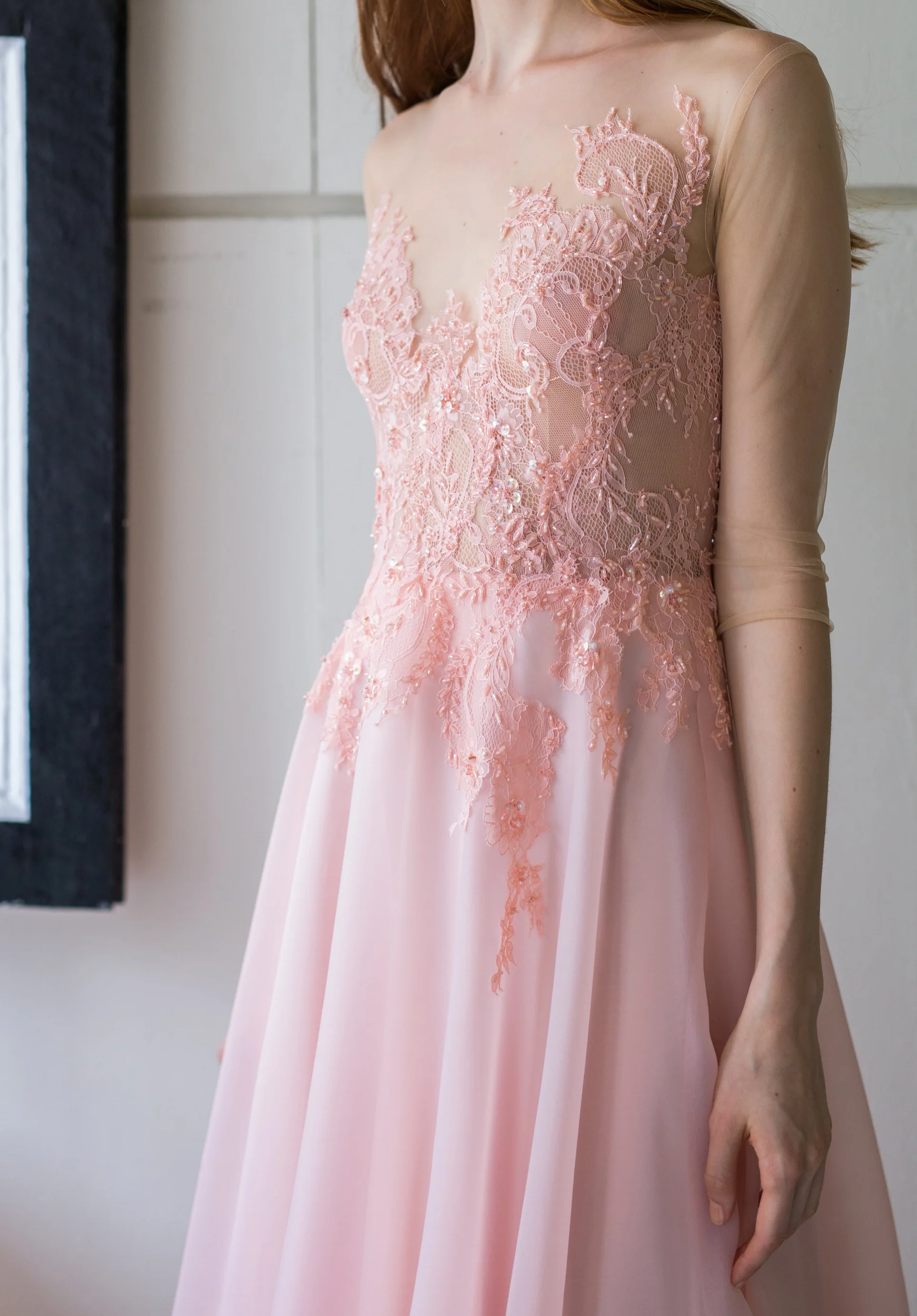 An illusion lace-top dress lined with Chantilly lace and layered with coral monochrome beads.