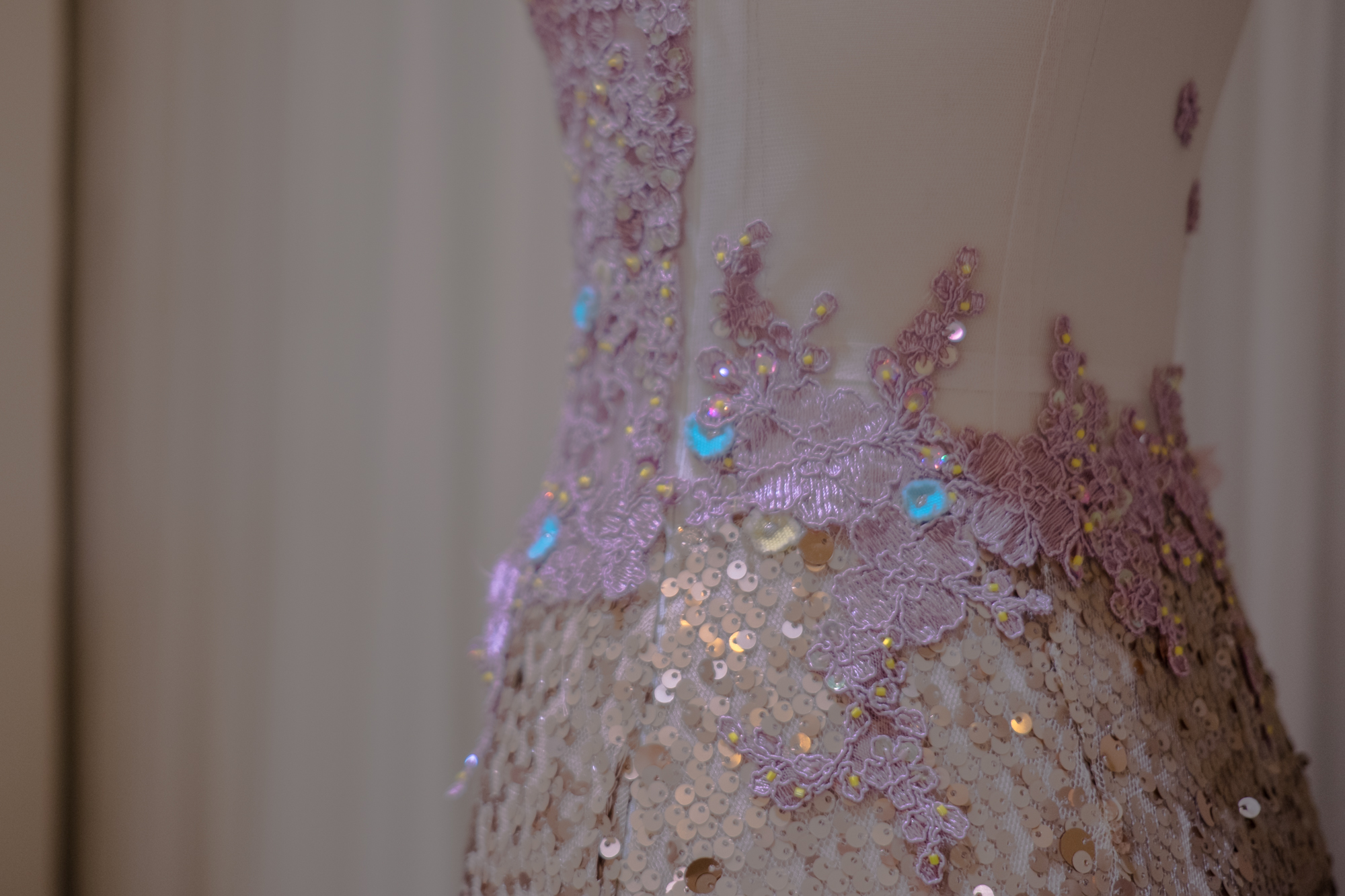 A sequined mermaid gown with corded lilac lace, brought to life with scattered yellow beads.