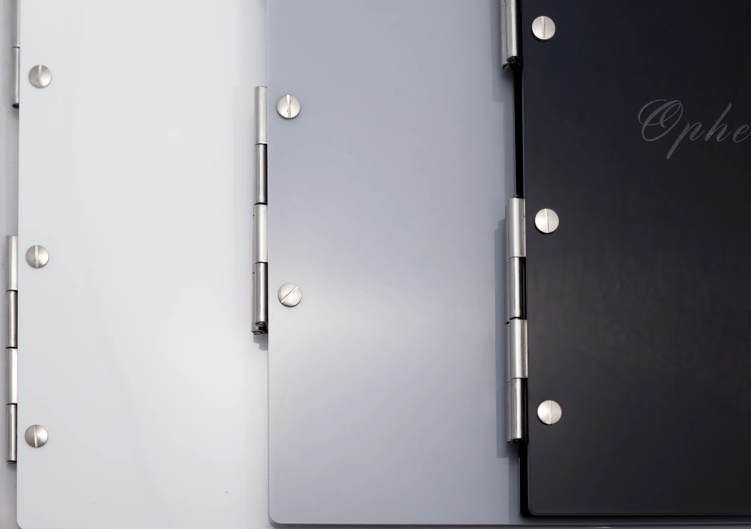 Close up of the stainless steel hinges on a grey, black and white acrylic perspex portfolio range