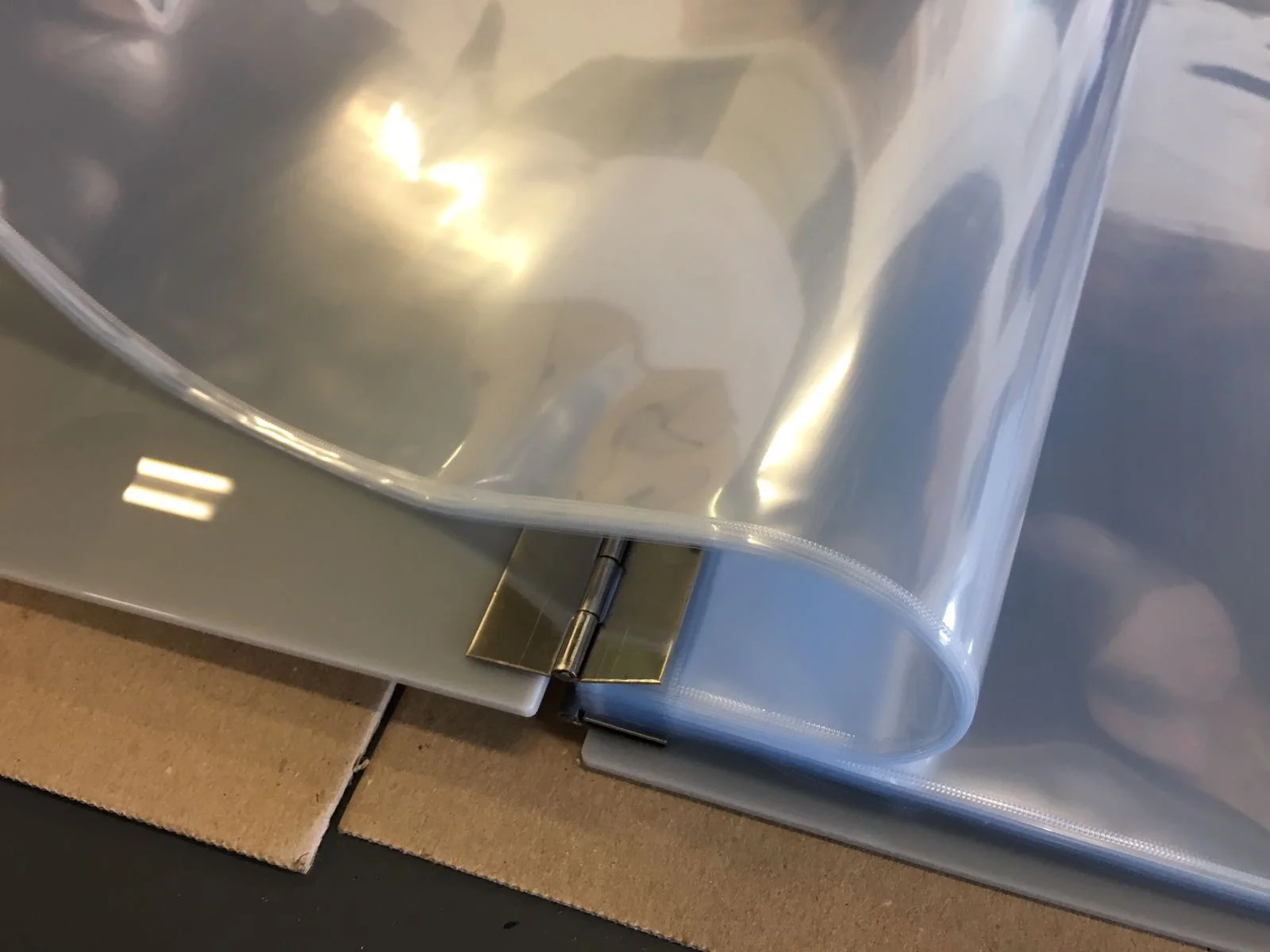 Archival quality sleeves inside a grey acrylic perspex presentation portfolio album