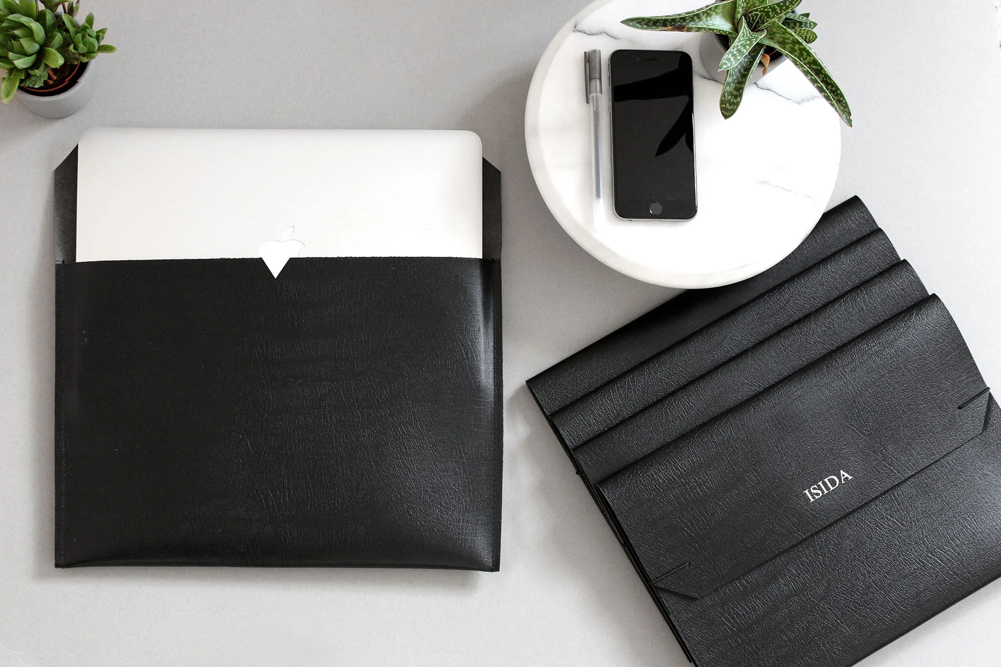 leather custom laptop sleeves with a mac inside showing foil embossed custom names