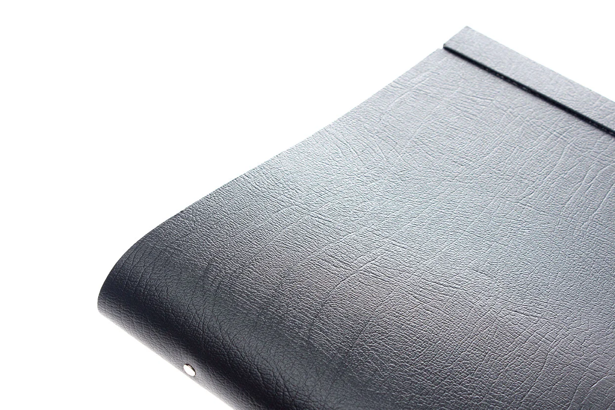 Close up of the texture of a black leather portfolio album
