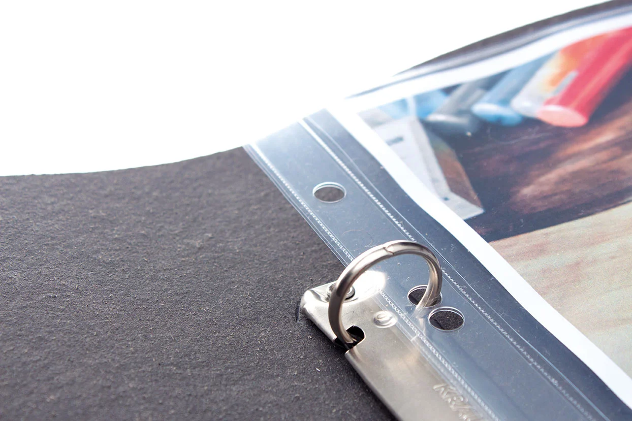 open black leather artists portfolio with a sleeve with artwork in
