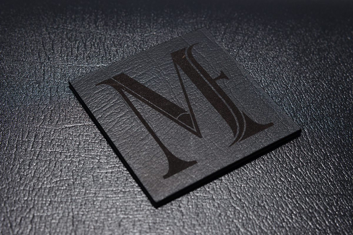 Close up sample of black leather engraved with a logo