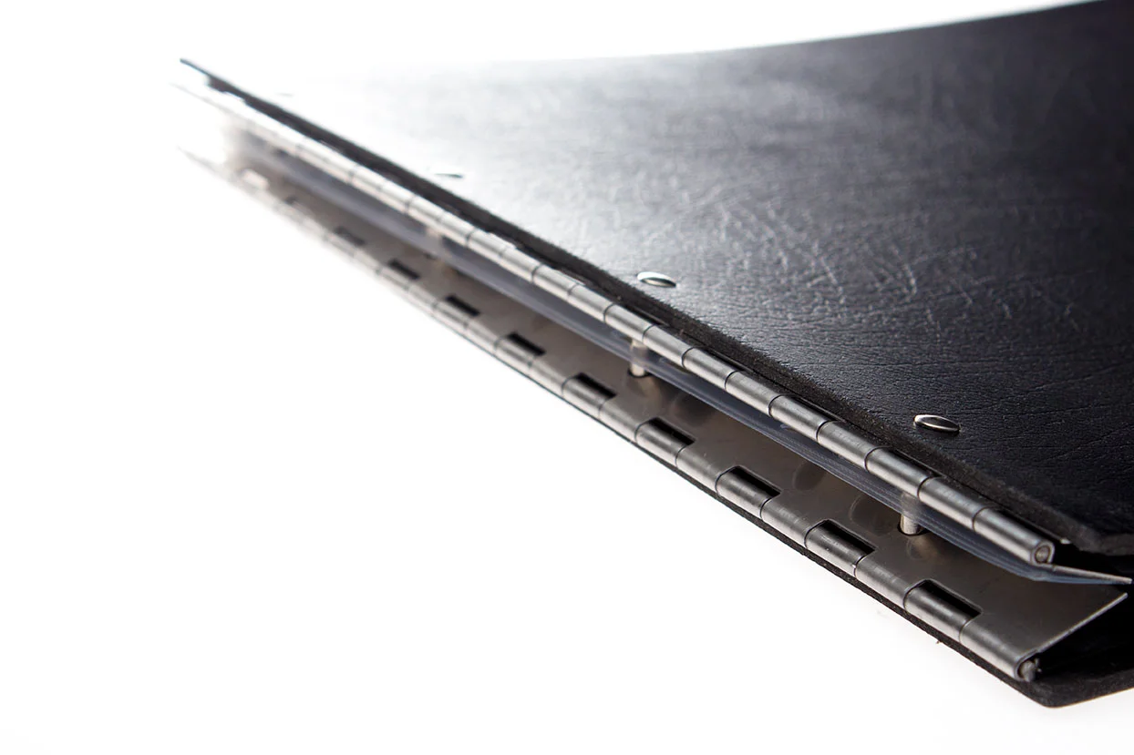 Close up of a custom leather portfolio showing how the binding posts secure your page