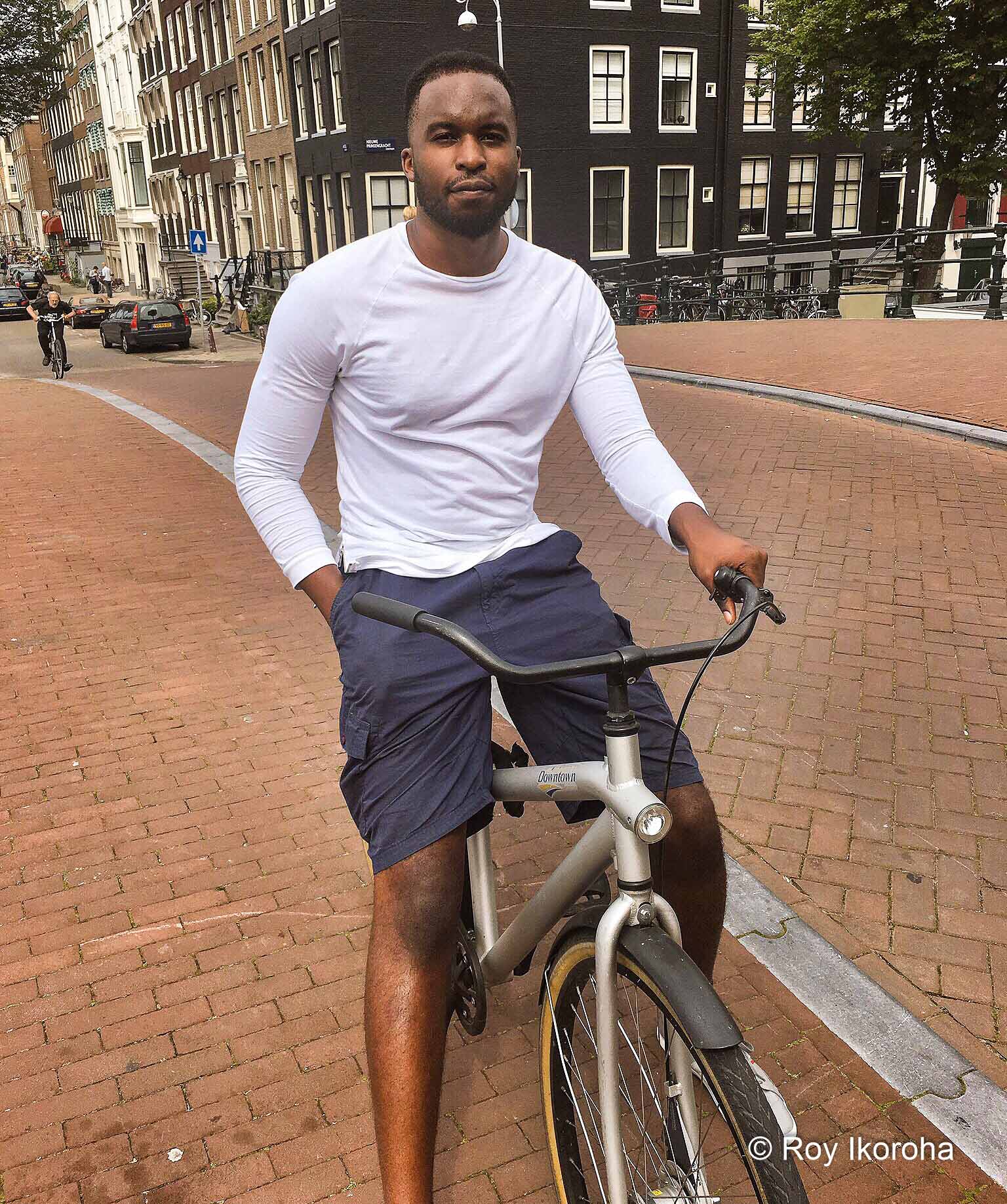 On a bicycle striking a pose in an Amsterdam street, Netherlands