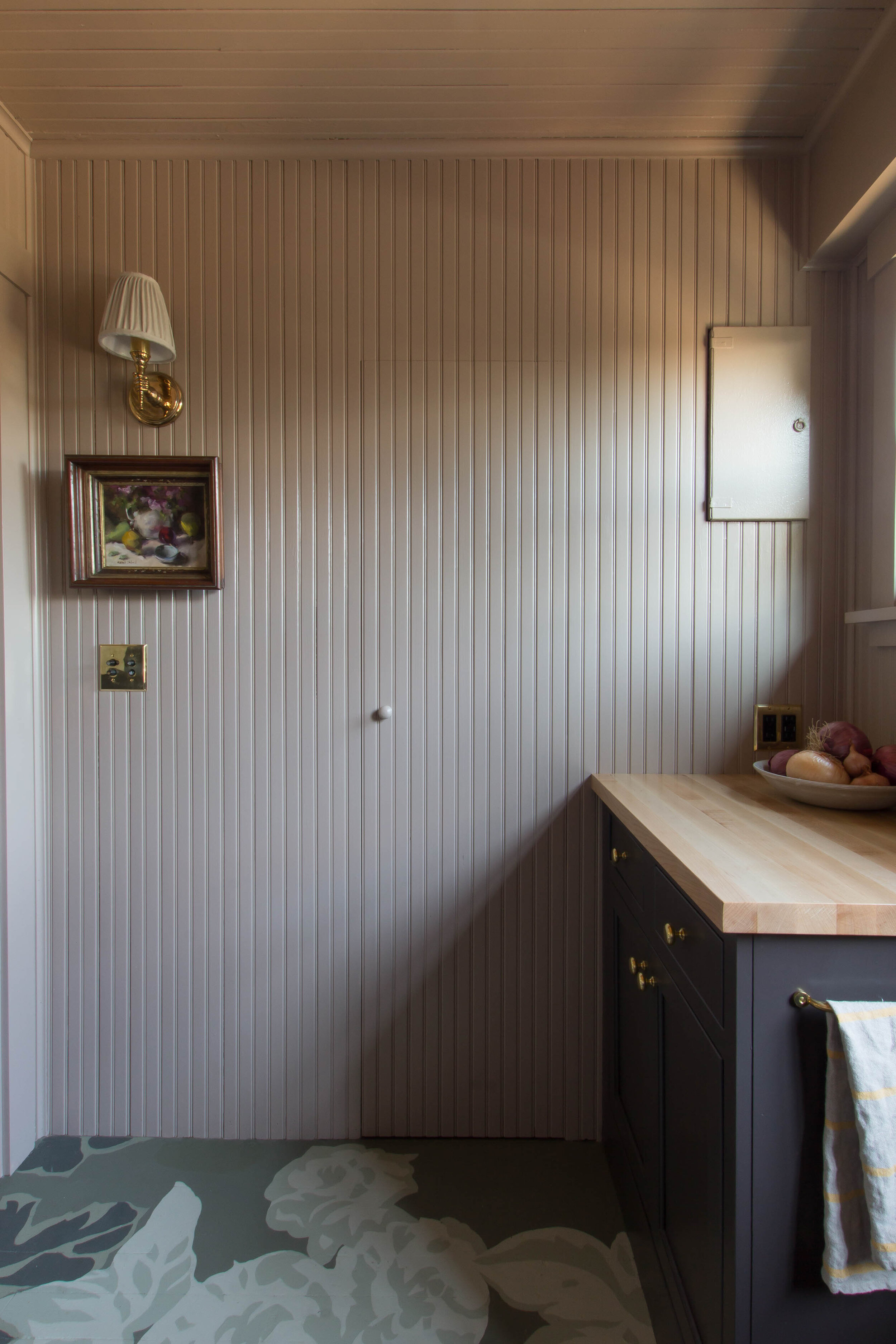  Seattle Scullery Designed by: Studio Laloc, Lauren L Caron - Photo by: Lauren L Caron © 2020  The beadboard wall paneling perfectly disguises the broom closet door 