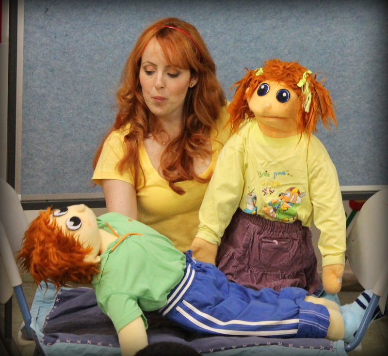 Using puppets, Yael learns the difference between good touch and bad touch.