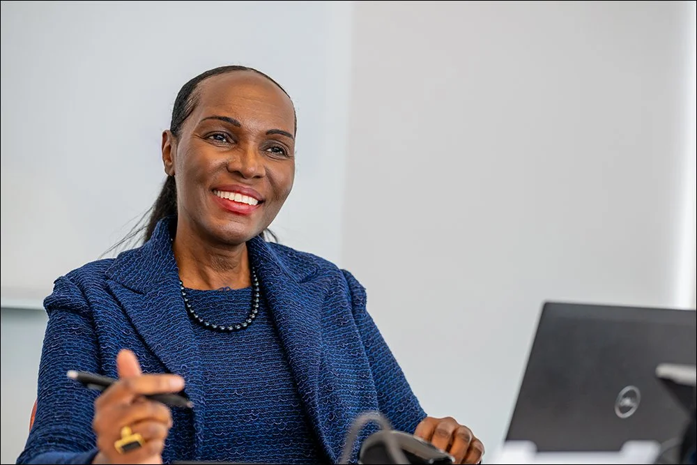 Executive portrait of business professional seated in office environment