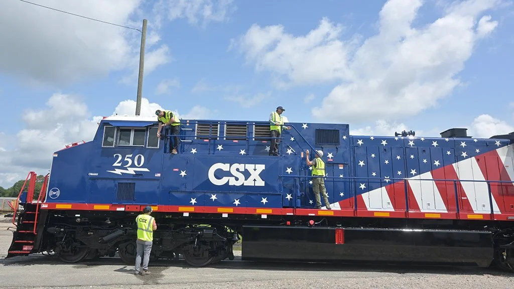 Production crew members rigging cameras on CSX locomotive No. 250 before filming the America 250 Executive Train in Waycross, Georgia.