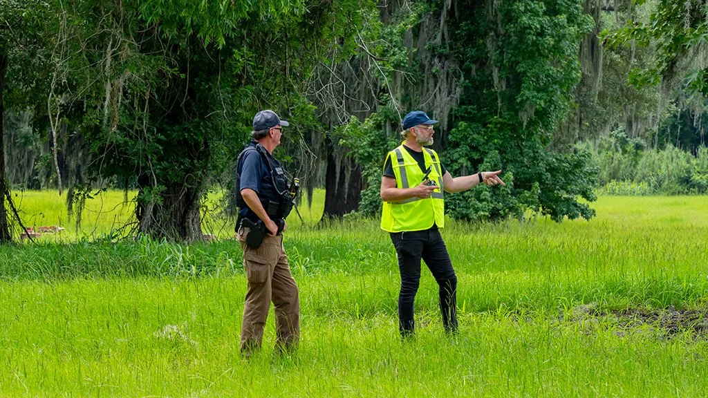 Michael LeGrand discussing the next drone filming location with a railroad team member before the train arrived.