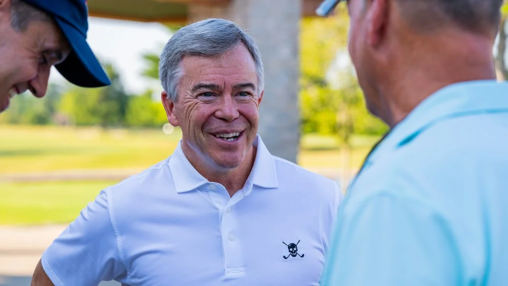 Retired U.S. Army General Bryan P. Fenton talks with attendees at the Pars With Patriots Invitational.