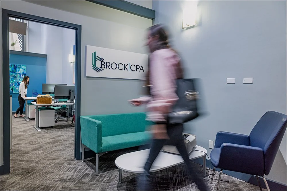 Modern office interior with employee walking through workspace in motion