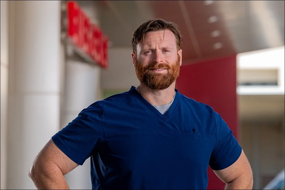 Doctor portrait outside hospital wearing scrubs in healthcare setting