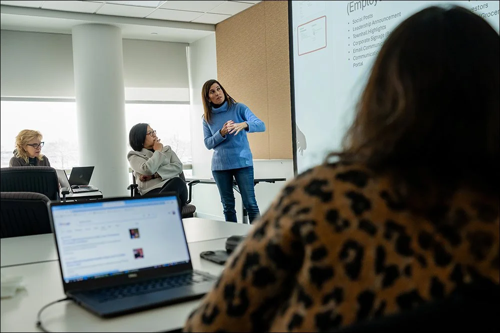 Professional leading presentation in conference room while team listens and takes notes