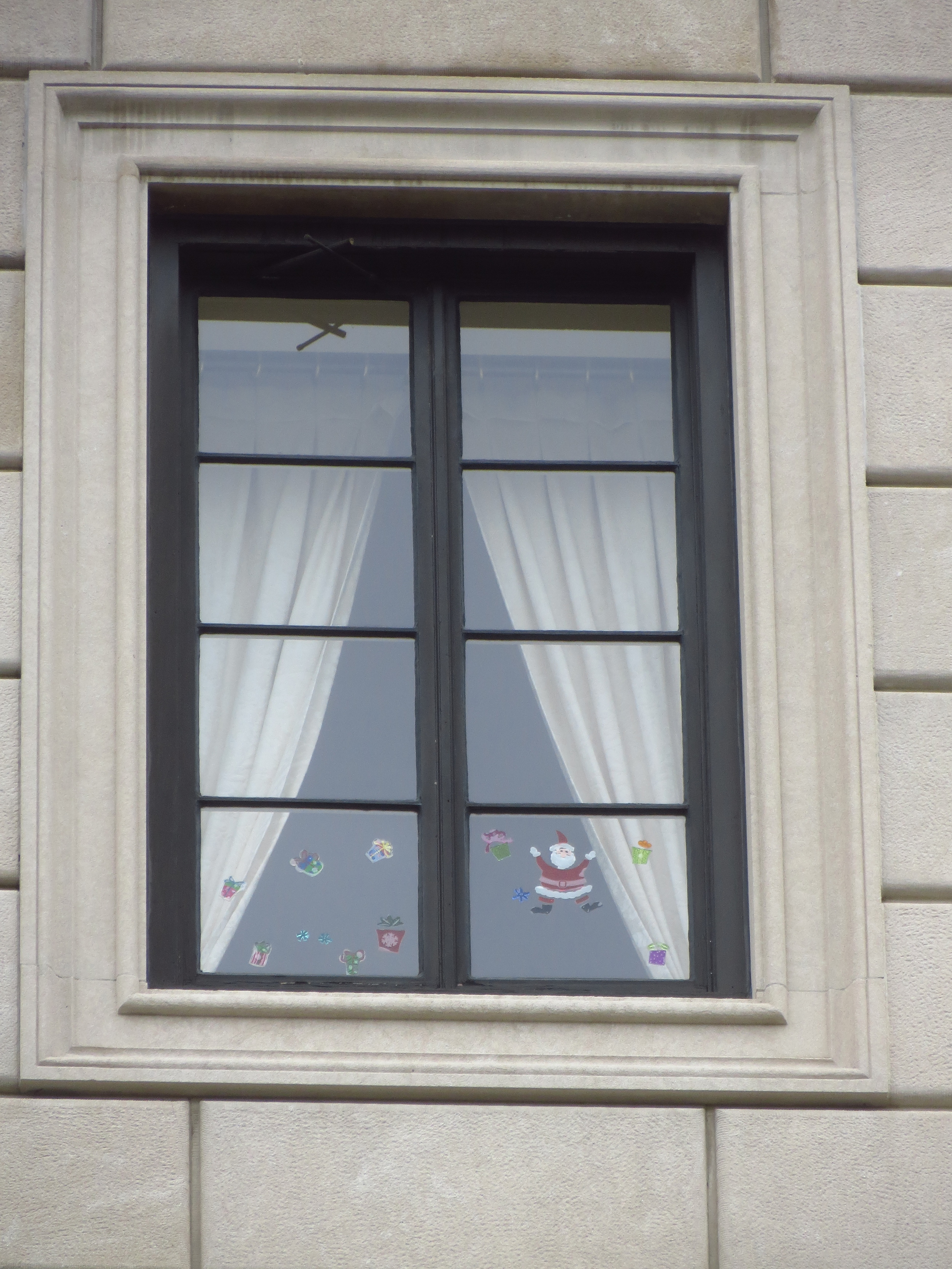 Holiday stickers in the 4th story windows of the French Consulate
