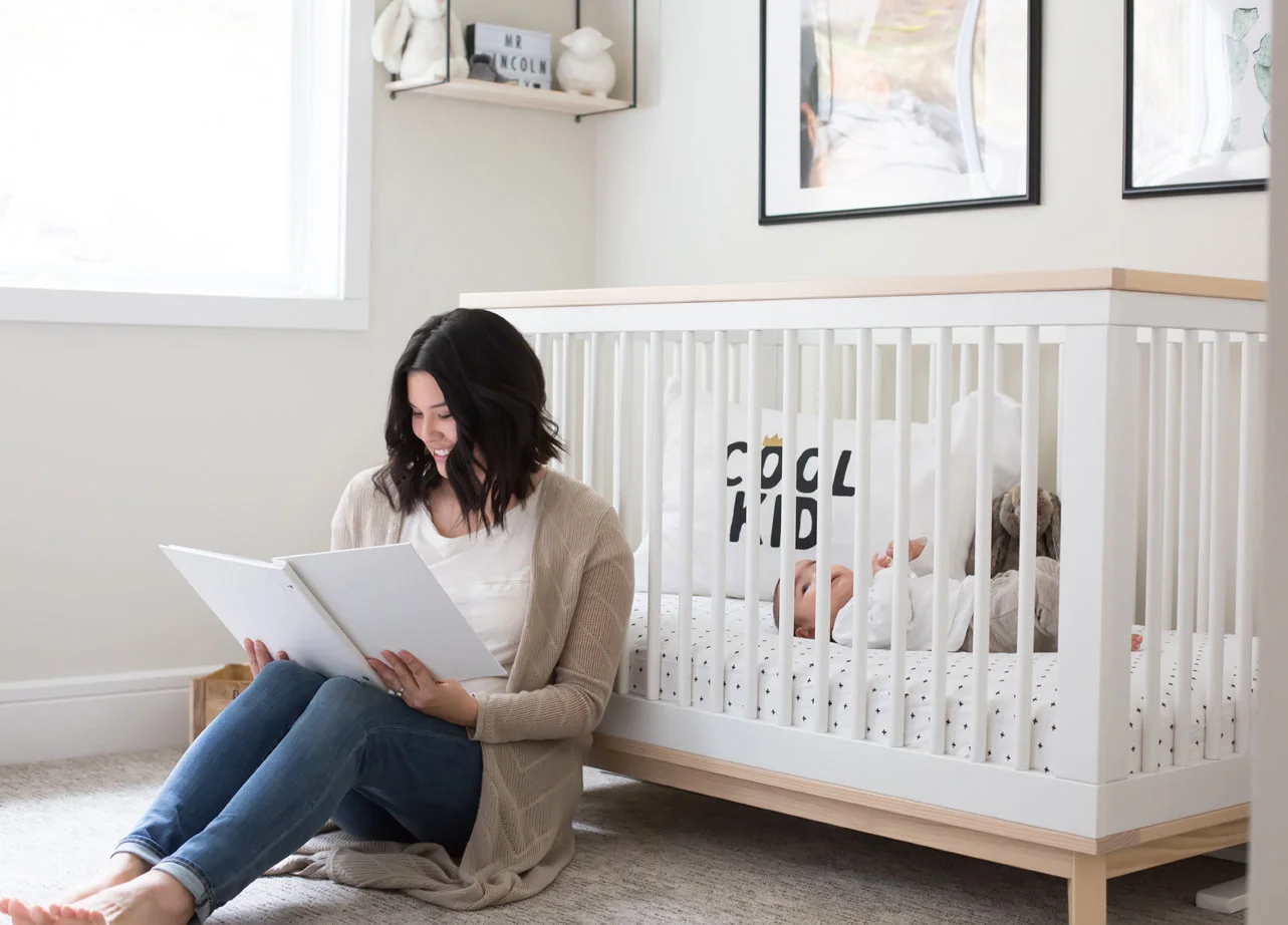 white crib with wood accent