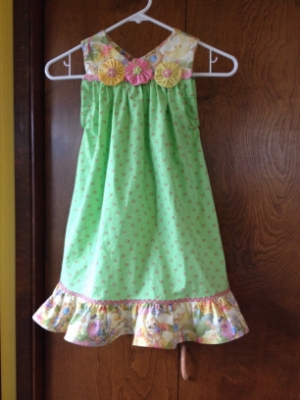 My first attempt at "Whimsey", adding yoyos with buttons, Ric-Rac, and ruffles. The pattern is very simple, only one piece! The yoke is cut from one pattern piece, the rest is just length and width to fit. The armholes are faced slits. Meant to pull over head with help. This would probably be a middle toddler, 2-3. 