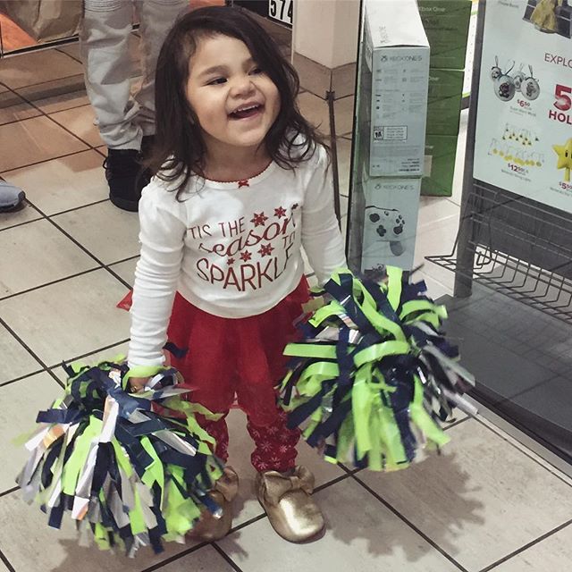 I dunno how I feel about paying $20 for some plastic strings, but they sure made her happy! 🤷🏻&zwj;♀️ #pompoms #seahawks #seagals #cheerleader #dimples #smile #happiness #tistheseason #shopping #gohawks