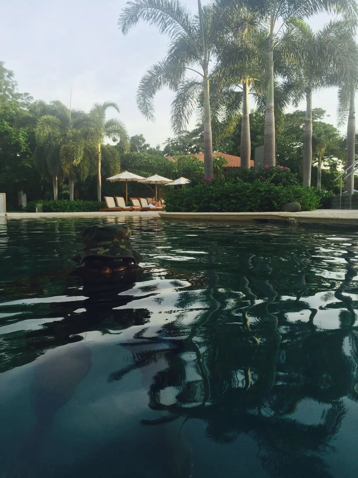 Upon first glance of this pic, you might be thinking I'm highlighting the beautiful scenery of the pool area, which I was but take a closer look. Hubs was trying to imitate a covert Navy Seal tactic in the water. If you didn't notice him initially, I'd say he did a pretty good job! He was playing the part guys, he had his camo hat on and everything. I needed that strategy back when I was under the water, not now, LOL!