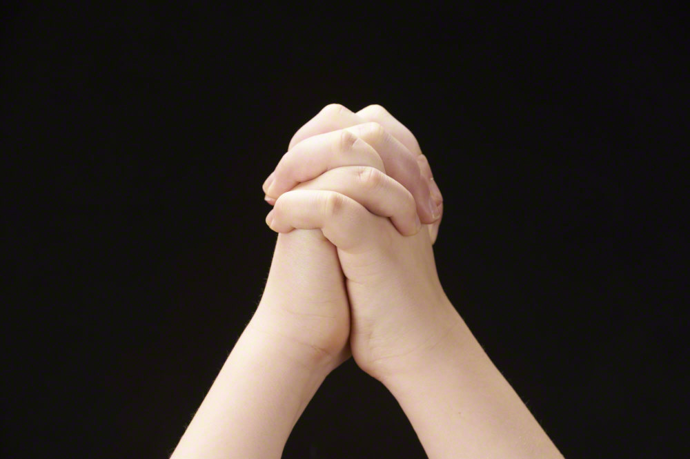 Folded hands of child